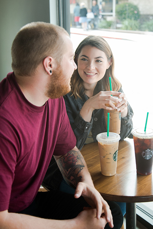 young man and woman at Starbucks drinking iced coffee and frappuccinos