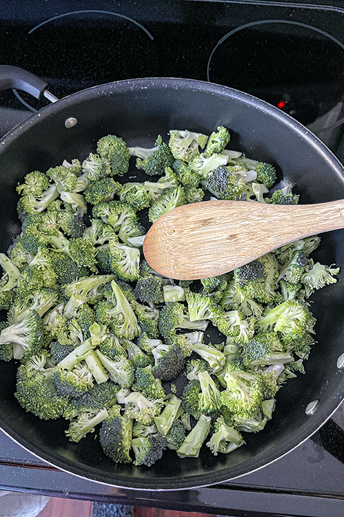 raw broccoli in a pan to steam on the stovetop