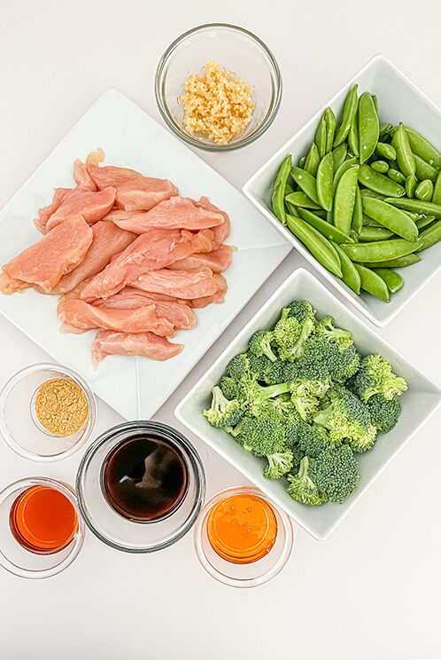 Healthy Stir Fry ingredients: chicken, broccoli, snap peas, sauces and seasonings