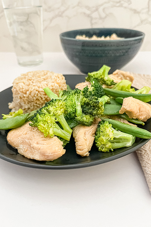 healthy stir fry with a bowl of rice and water